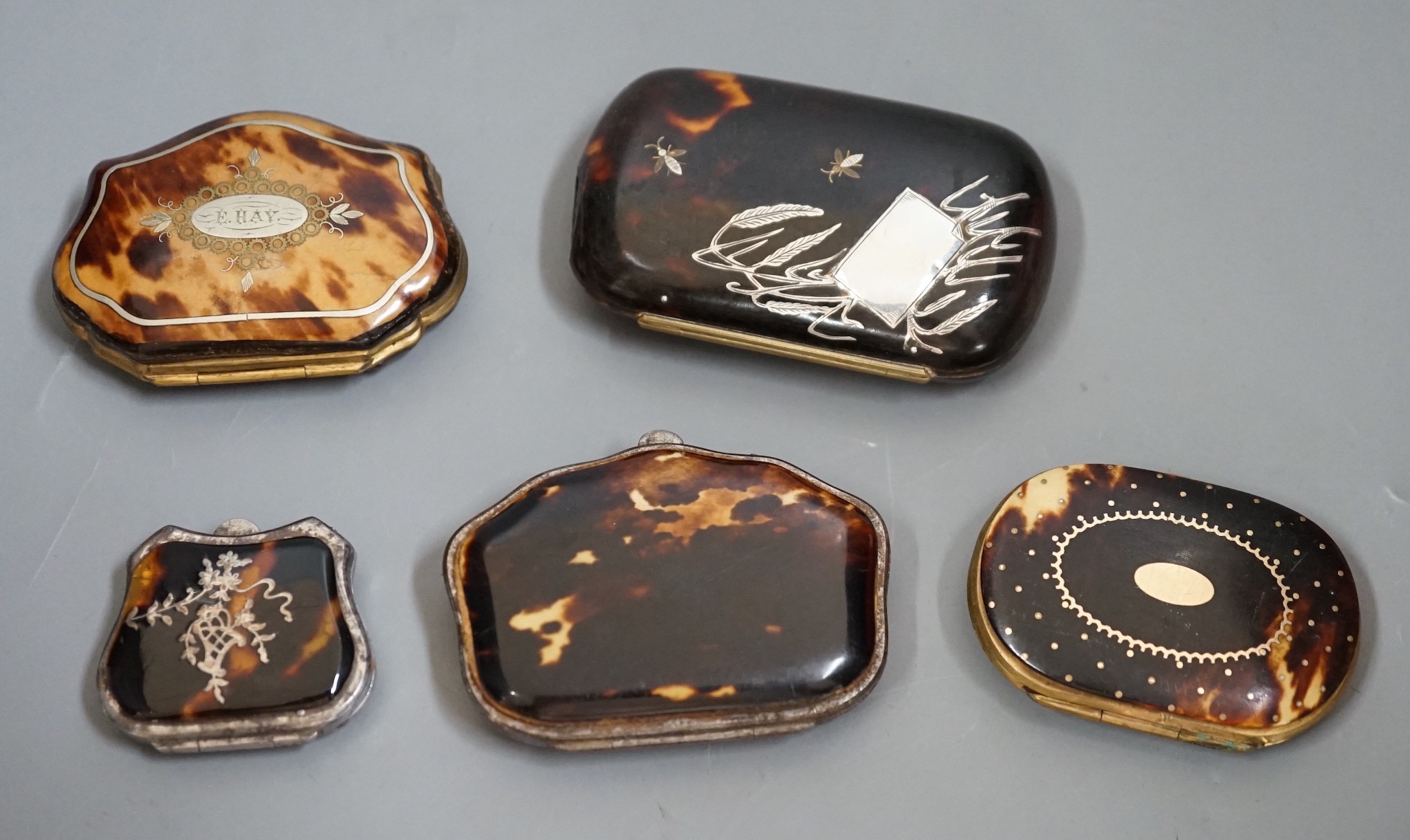 Five 19th century tortoiseshell and piqué work purses of varying sizes and designs